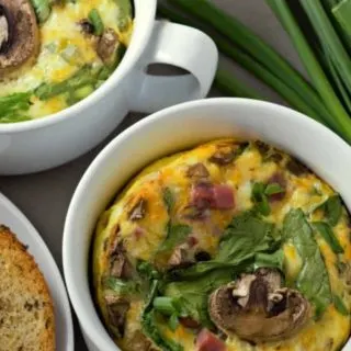 Baked Cheesy Ham Spinach Omelets in two casserole dishes.