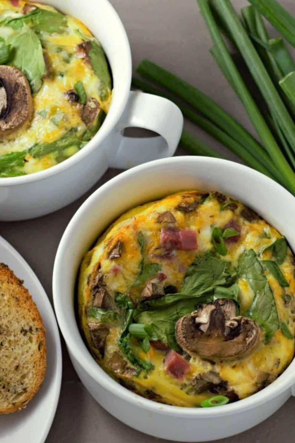 Baked Cheesy Ham Spinach Omelets in two casserole dishes.