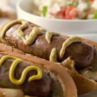 Beer Brats and Caramelized Onions on a plate.