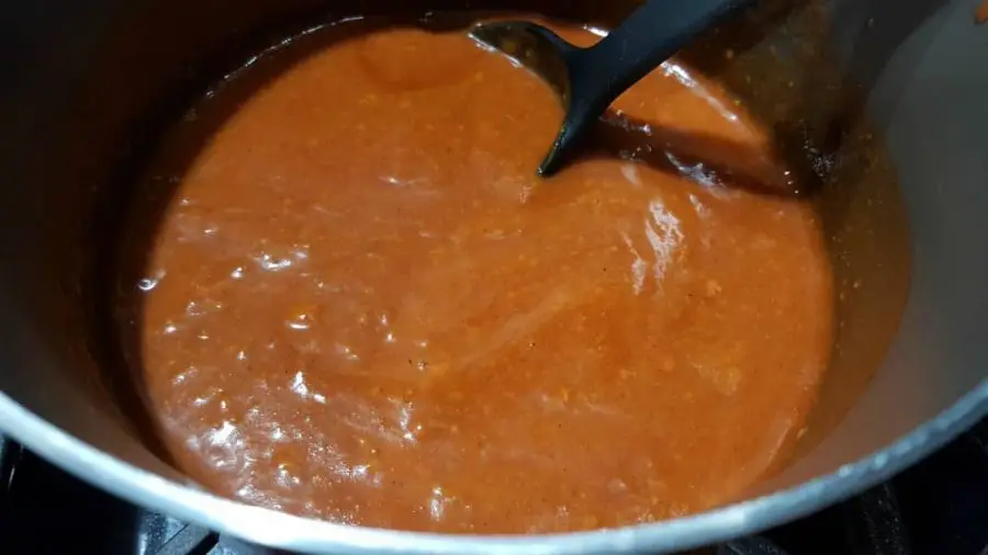 Wet Burritos Sauce cooking in a sauce pan.
