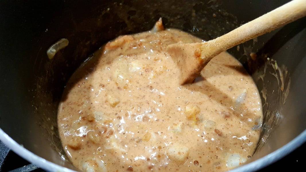 korma coconut milk sauce cooking in a pan.