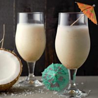 Two Pina Coladas in stemmed beer glasses