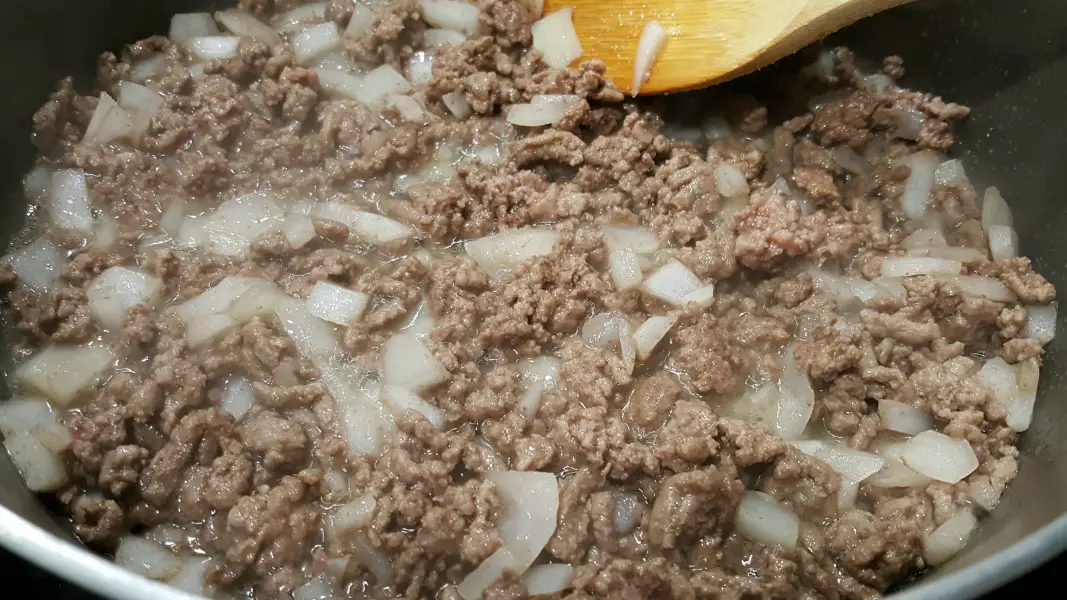 cooking ground beef and onion for tater tot casserole.