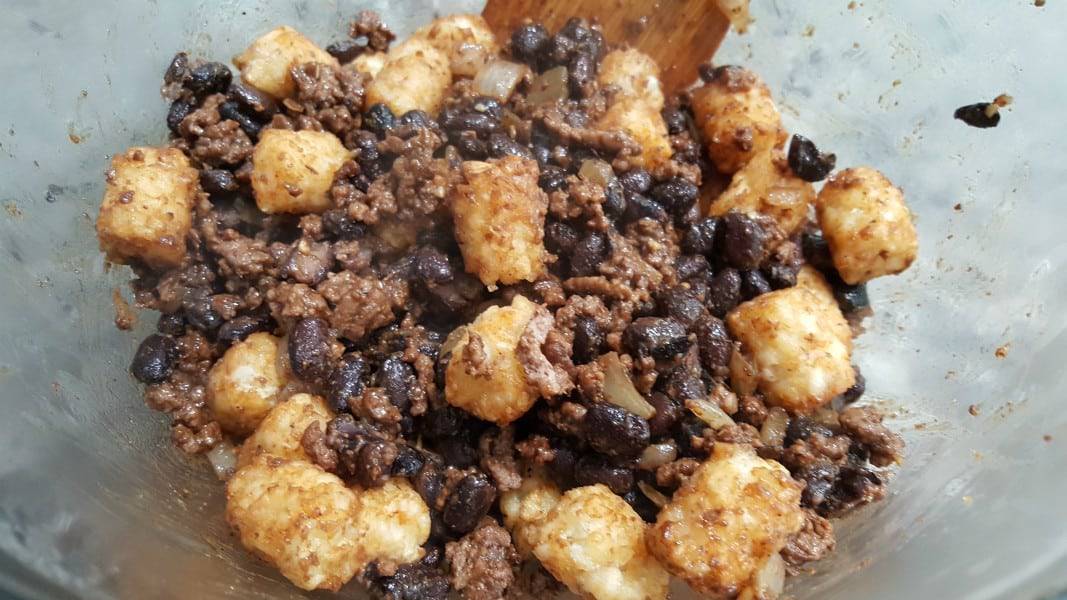 ground beef, black bean, and tater tot mixture in a bowl.