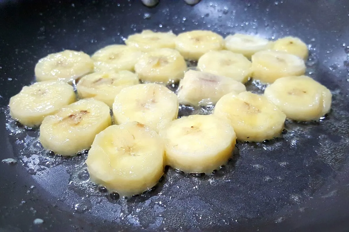 sliced bananas cooking in butter.