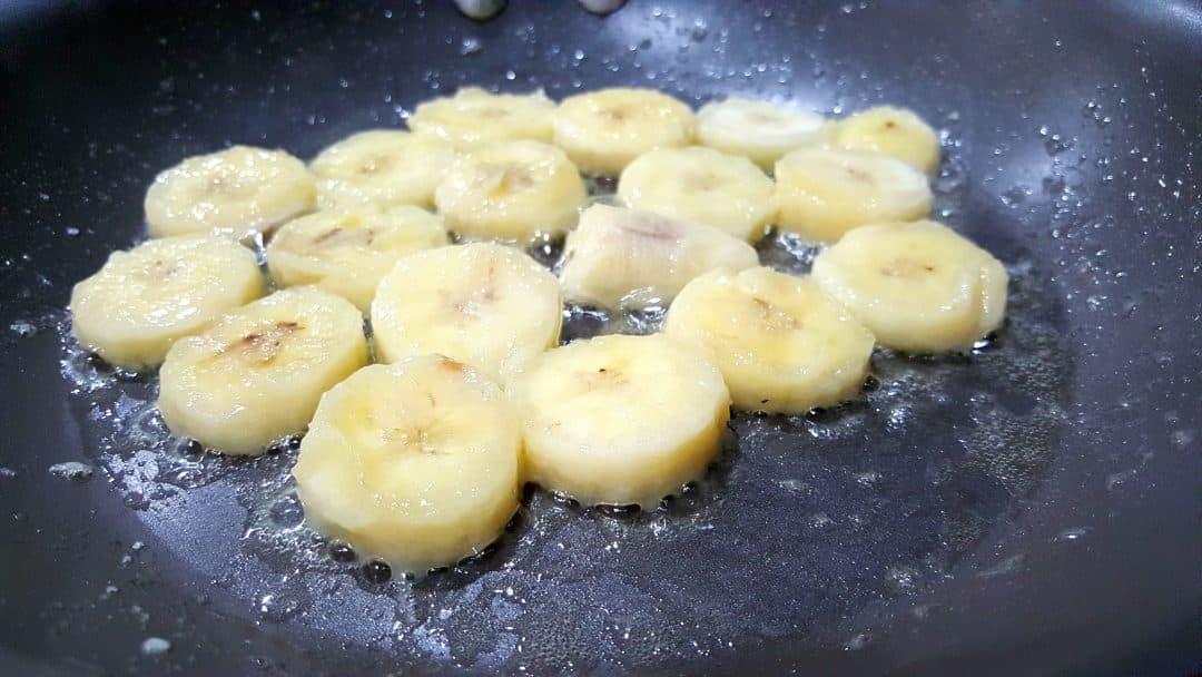 sliced bananas cooking in butter.