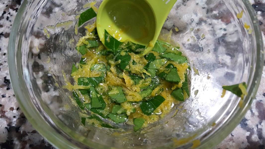 parsley, lemon zest, olive oil, and lemon juice mixed in a bowl.