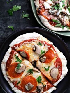 Grilled Pizza on two plates.
