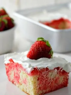 Homemade Strawberry Poke Cake on a plate.