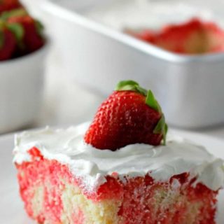 Homemade Strawberry Poke Cake on a plate.