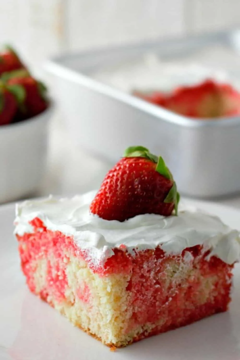 Homemade Strawberry Poke Cake on a plate.