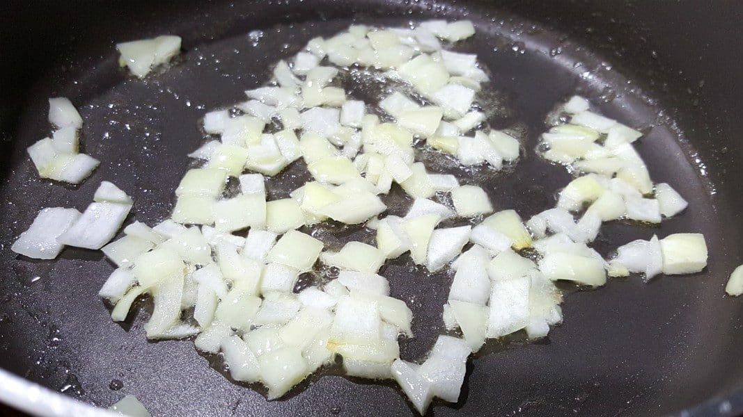 diced onion cooking in a skillet for swedish meatballs