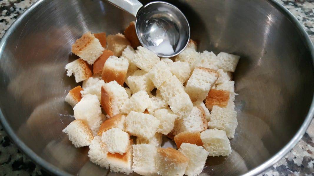 cubed bread and milk in a mixing bowl.