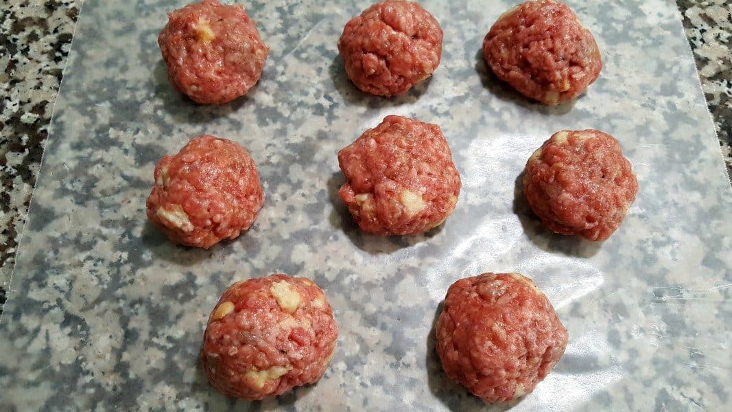 8 uncooked meatballs on wax paper
