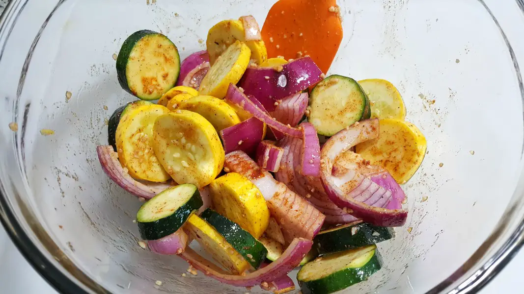 zucchini, yellow squash, and red onion mixed with garlic, olive oil, paprika, salt and pepper.