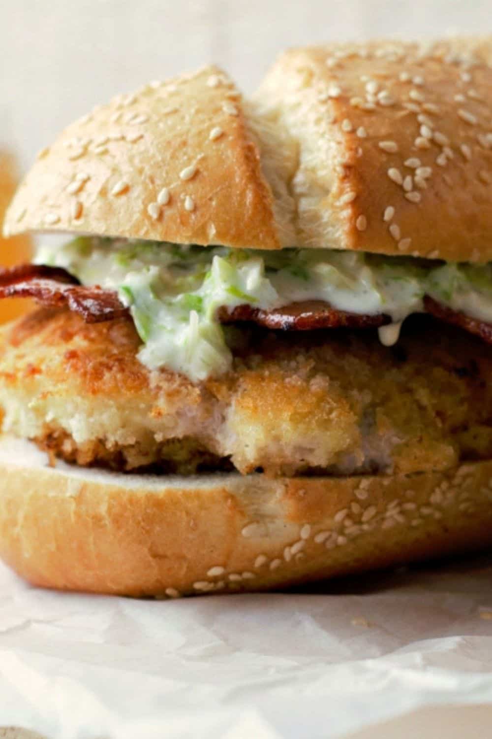 Fried Chicken Bacon Parmesan Sandwich on parchment paper.