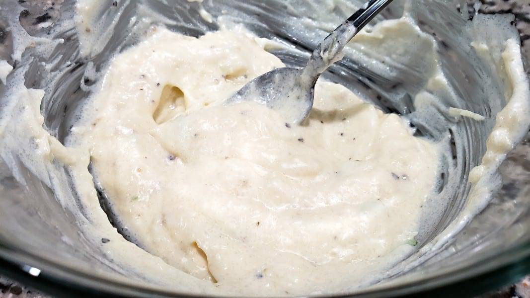 a creamy mayo, surgar, salt and pepper mixture in a bowl.