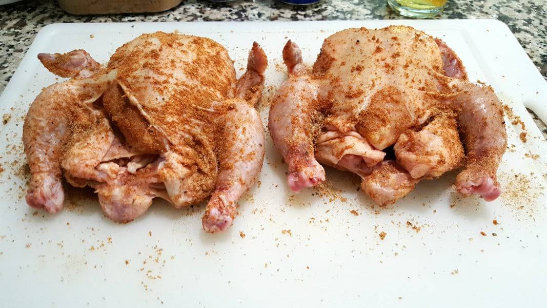 dry rub all over two Cornish game hens.