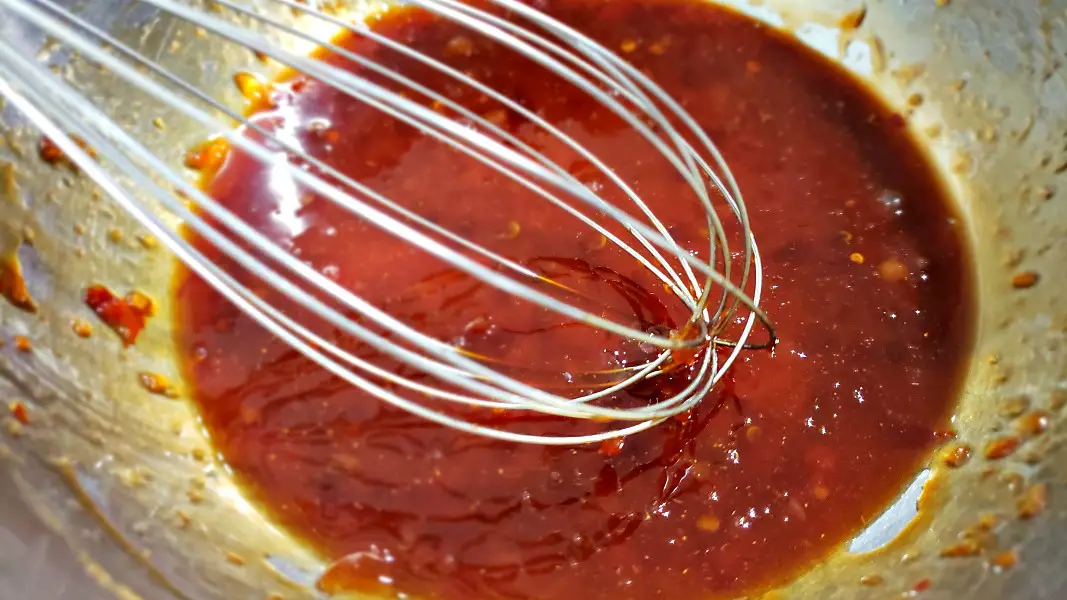 Thai sweet chilli sauce, soy sauce, and ground ginger mixed in a bowl.