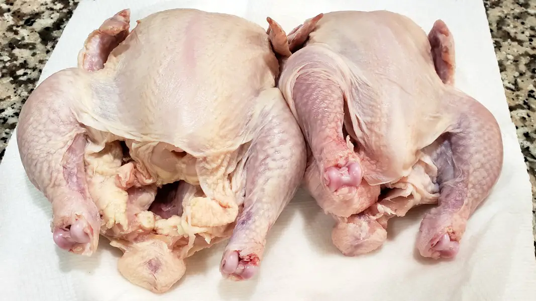 two Cornish game hens on paper towel.