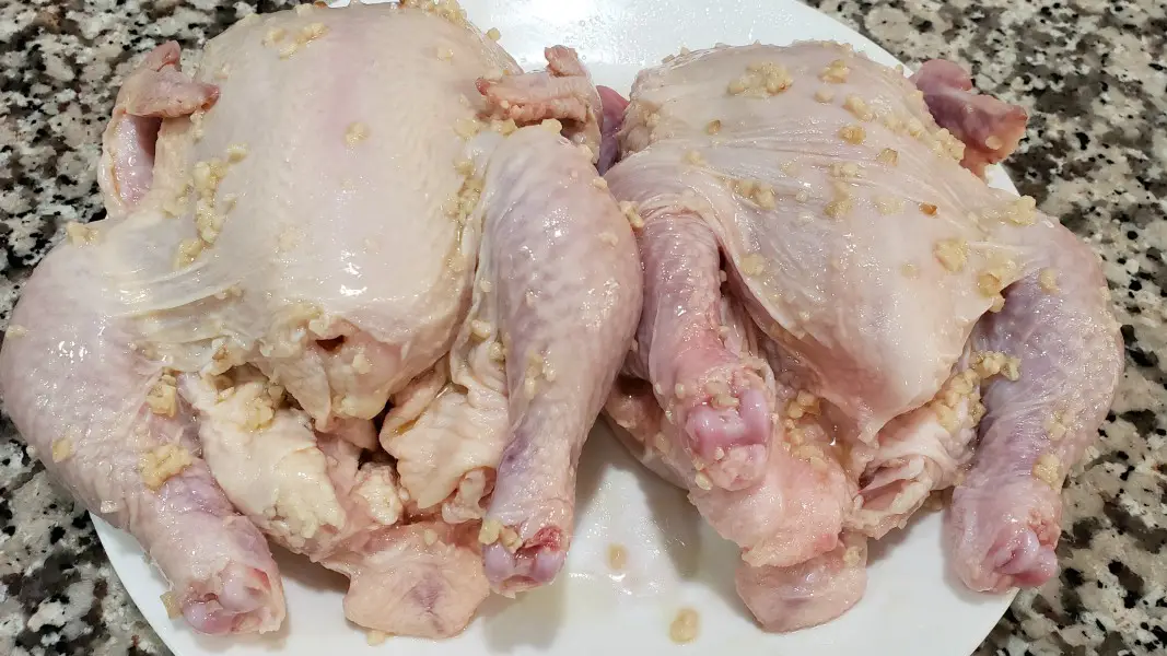 two cornish hens rubbed with oil and garlic.