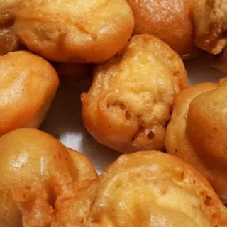 Beer Battered Deep Fried Mushrooms on paper towel.