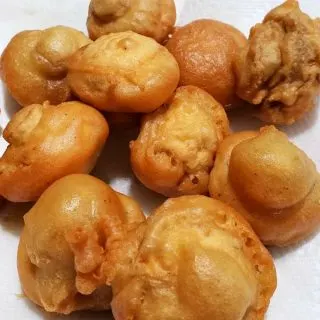 deep fried beer battered mushrooms draining on paper towel