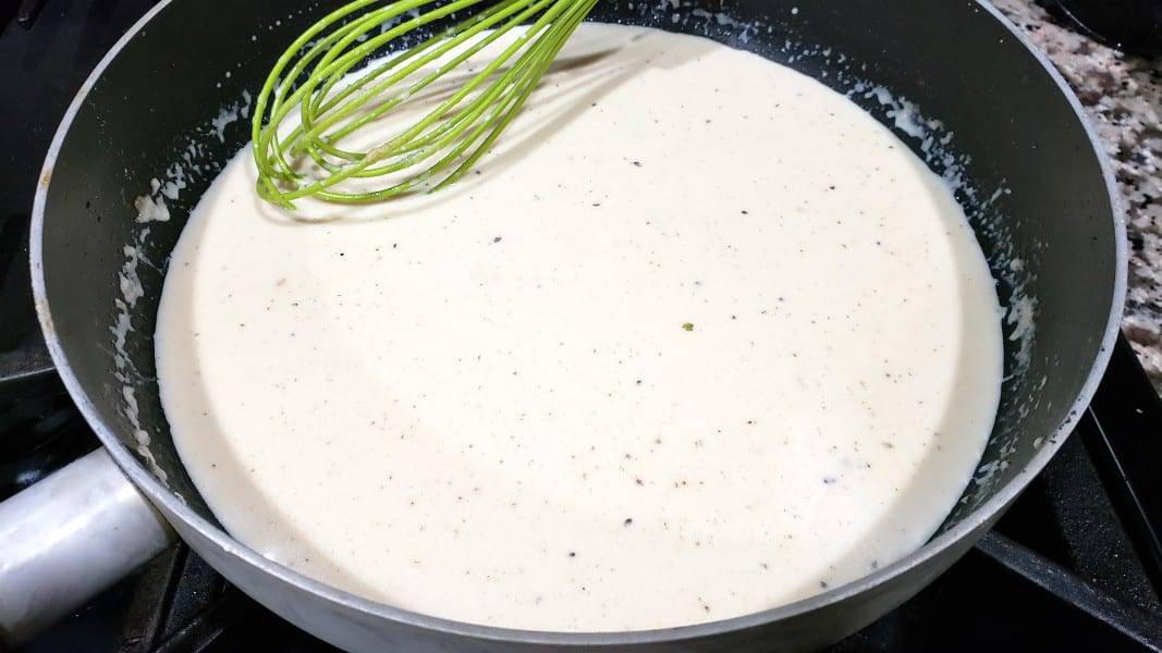 southern black pepper gravy cooking in a pan.