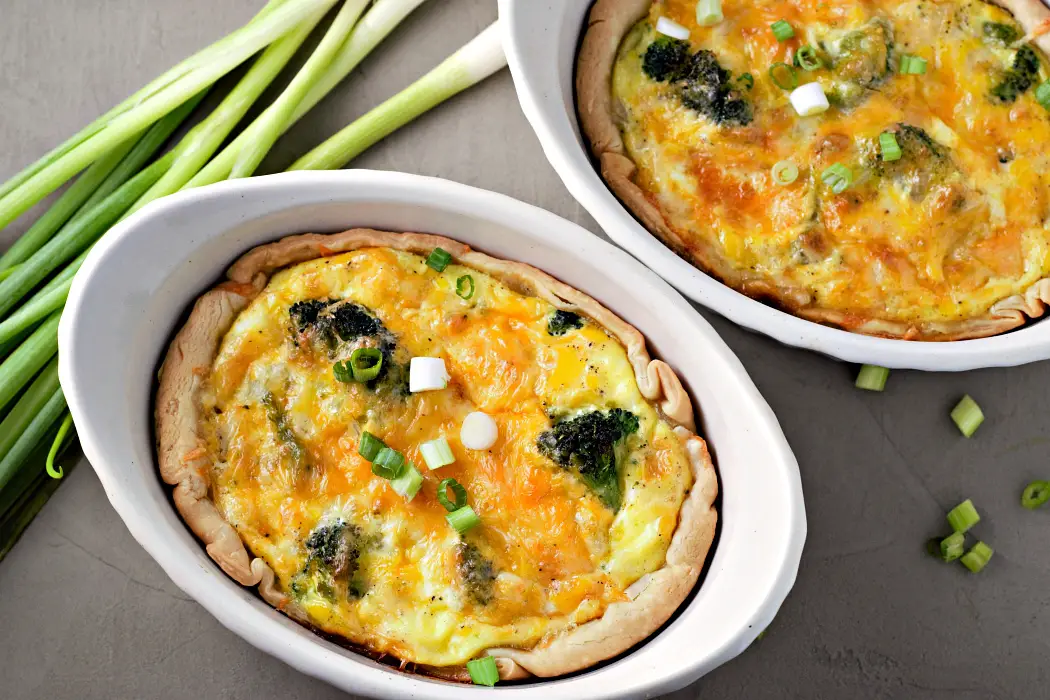 Individual Broccoli Cheese Quiche in two baking dishes.