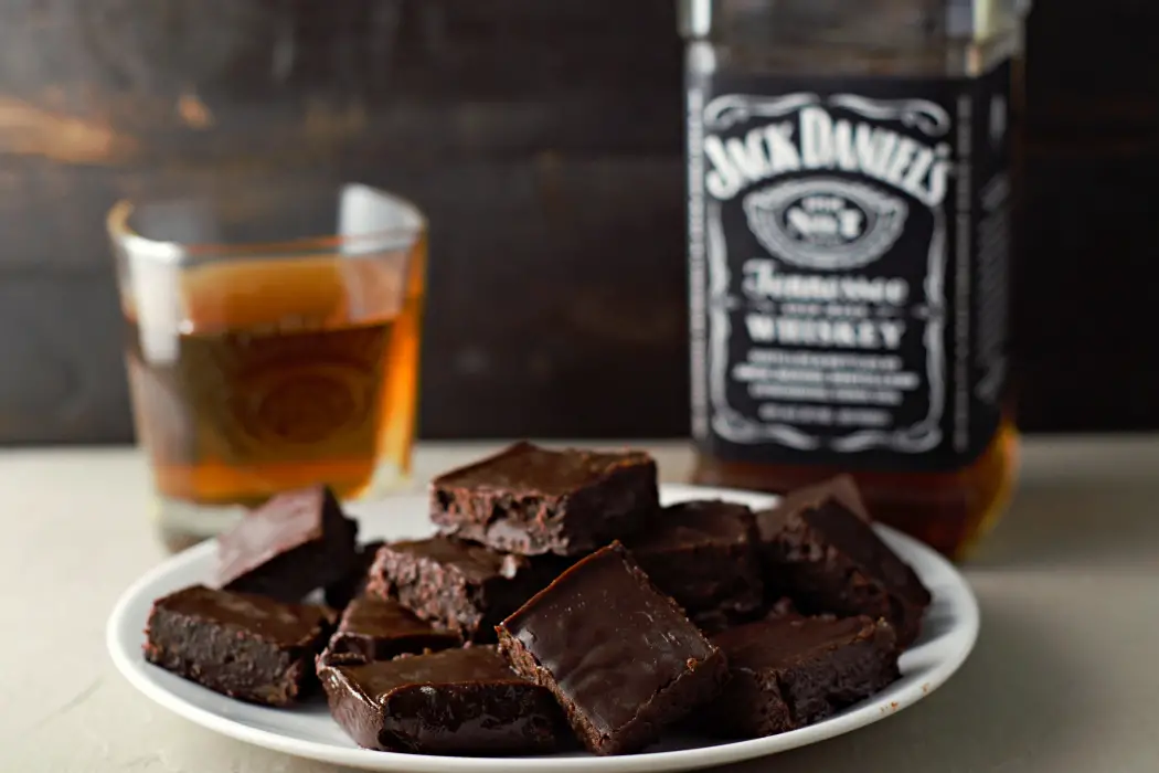 chocolate Fudge made with Jack Daniel's with a glass and bottle of whiskey.