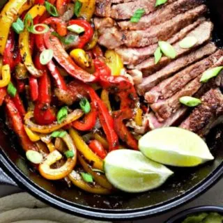 Ribeye Steak Fajitas in a cast iron skillet.