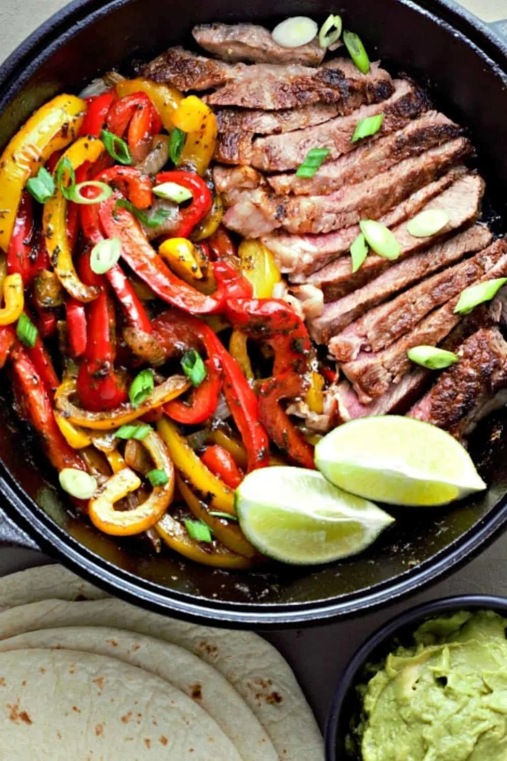 Ribeye Steak Fajitas in a cast iron skillet.