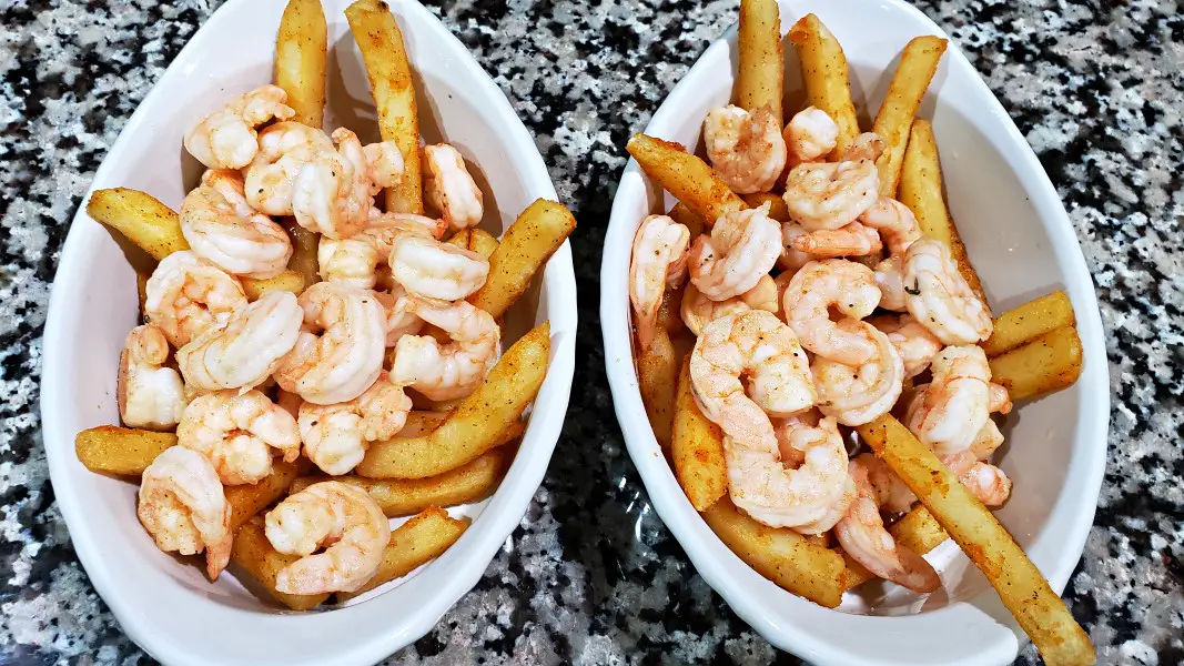 seasoned fries and shrimp in baking dishes.