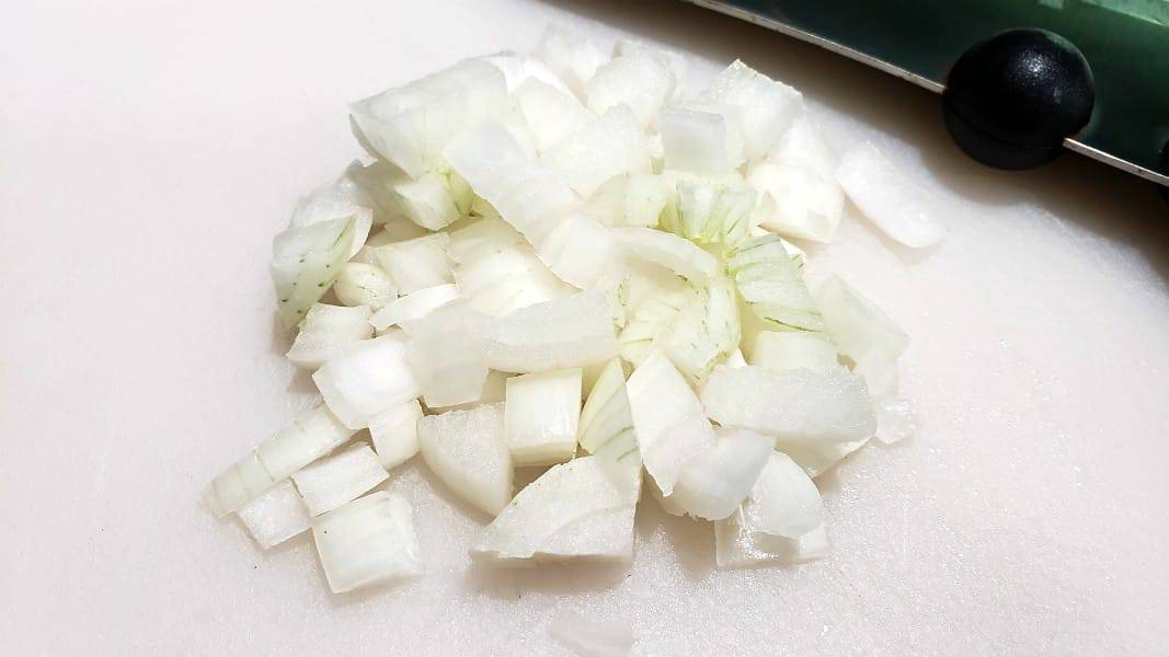 diced sweet onions on a cutting board.