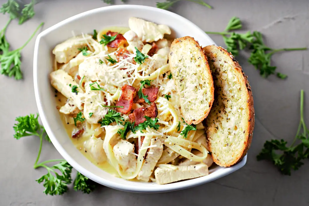 Classic Chicken Carbonara in a white bowl with toast.