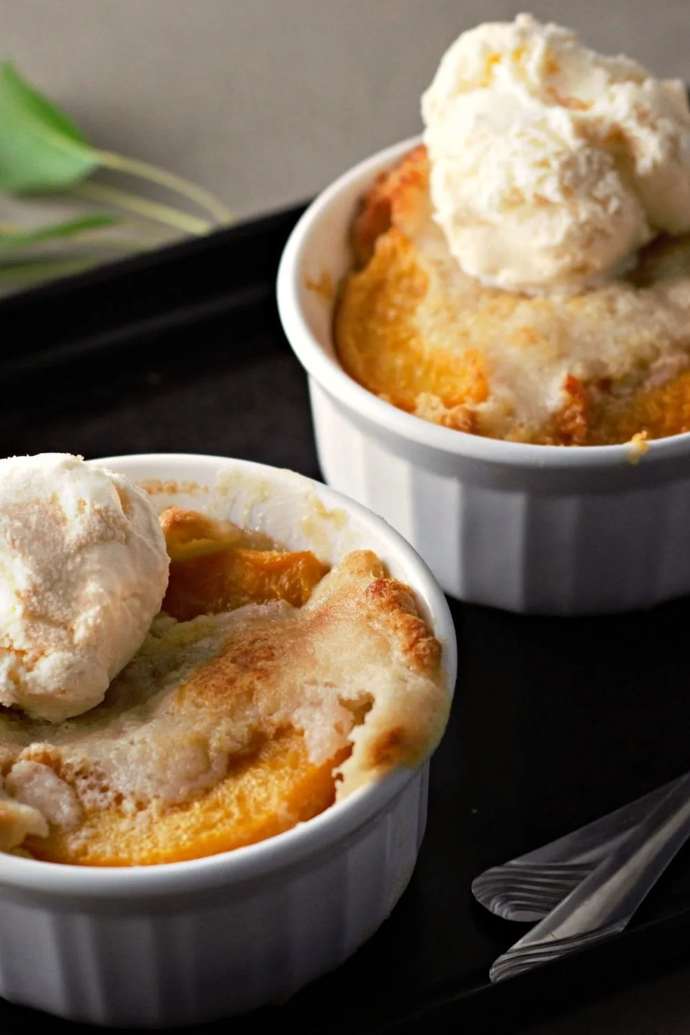 two Peach Cobblers in ramekins.