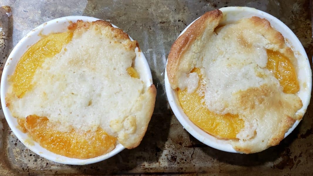 two baked peach cobblers
