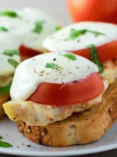 two Open Face Chicken Caprese Sandwiches on a plate.