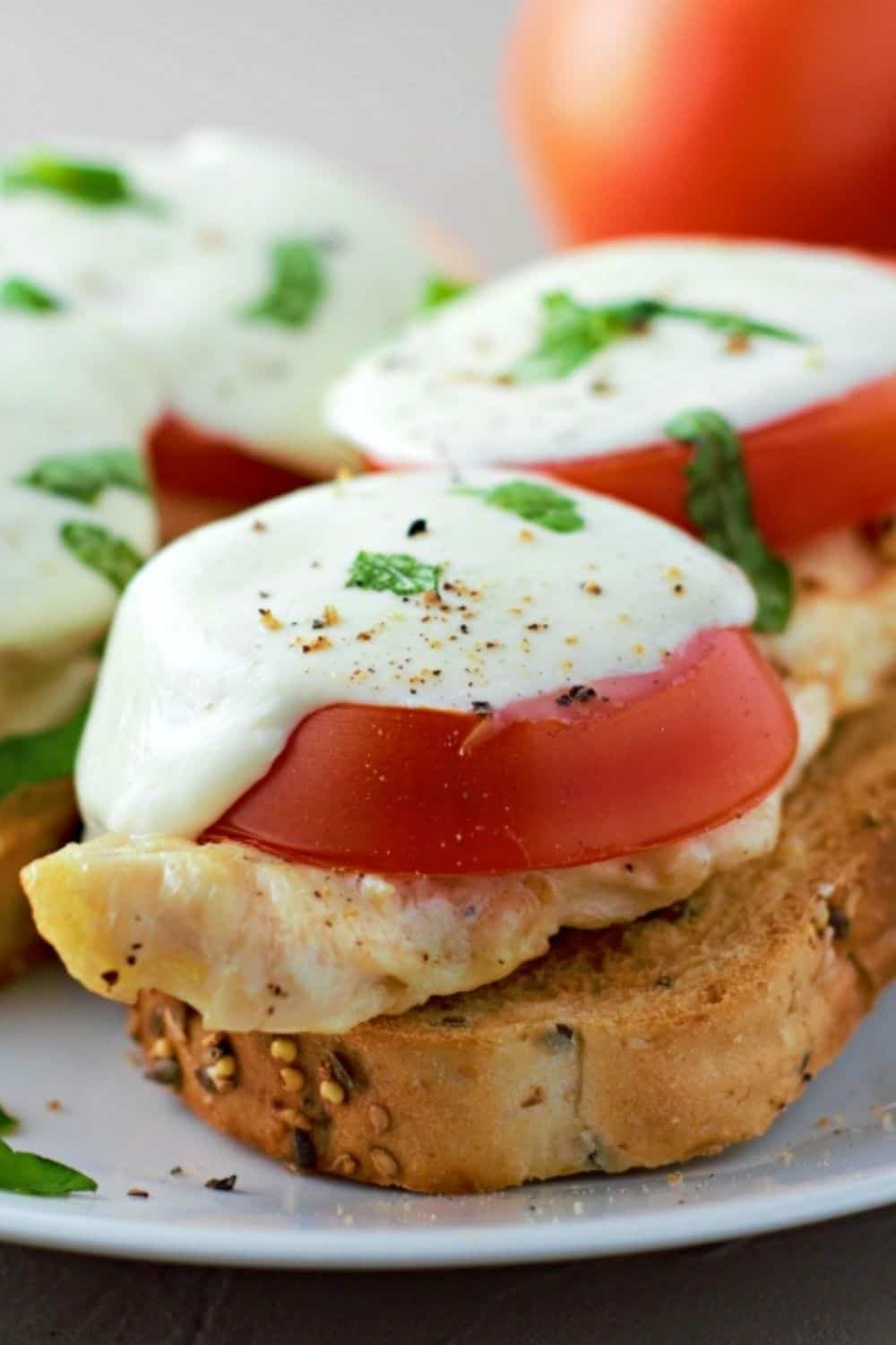 two Open Face Chicken Caprese Sandwiches on a plate.