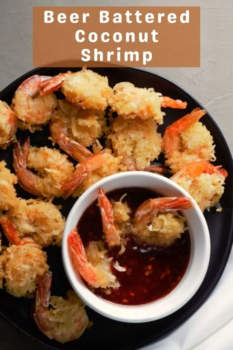 Beer Battered Coconut Shrimp on a plate with a bowl of dipping sauce.