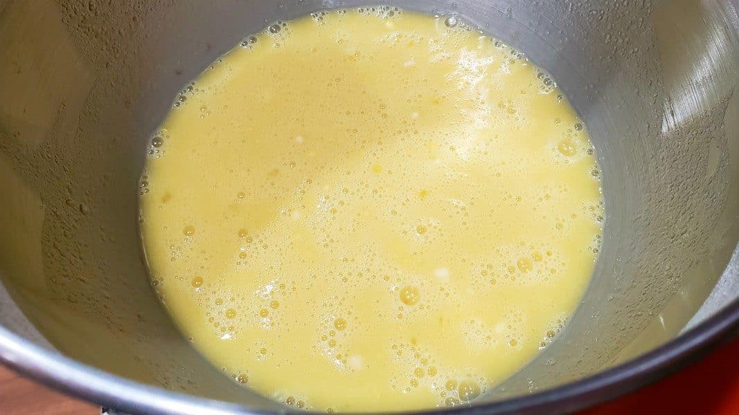 eggs, sugar, lemon juice, and flour mixed together in a stand mixer bowl