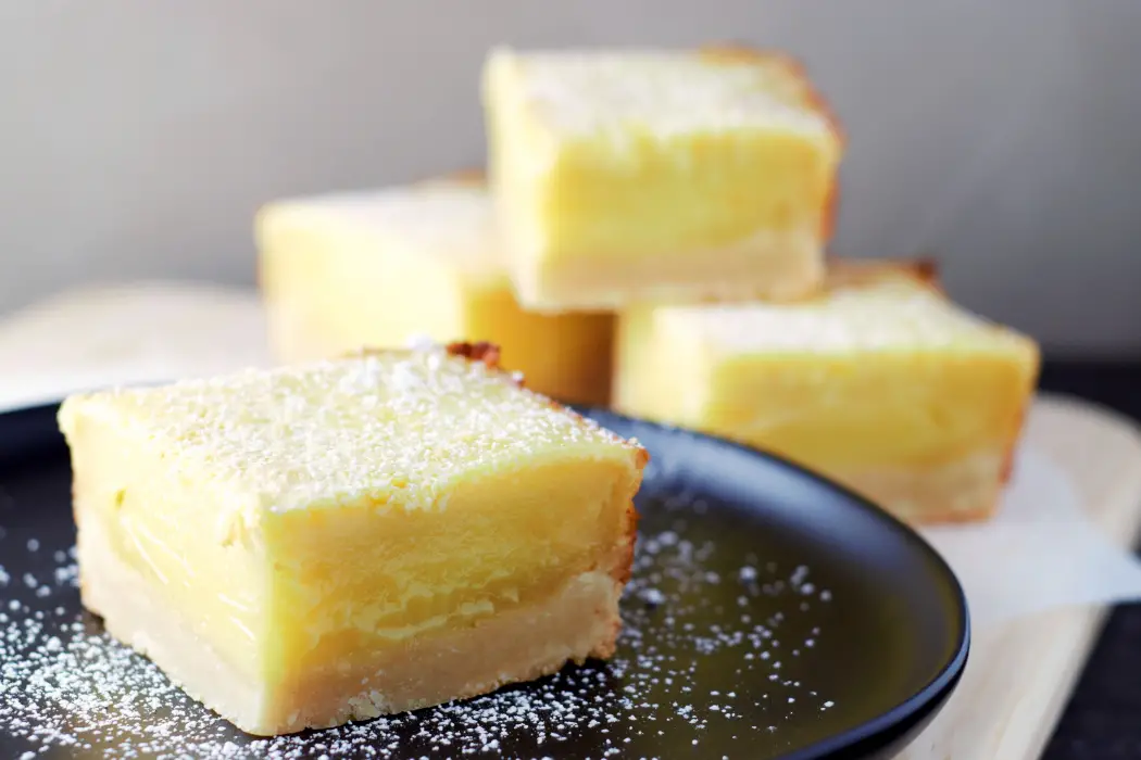 a small batch of Easy Mile High Lemon Bars sprinkled with powdered sugar.