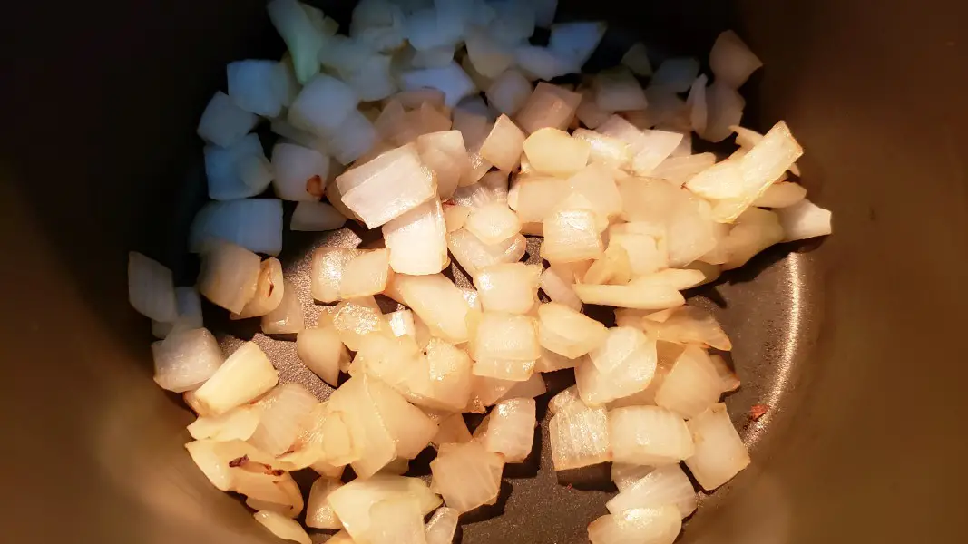 onions cooking in a sauce pan.