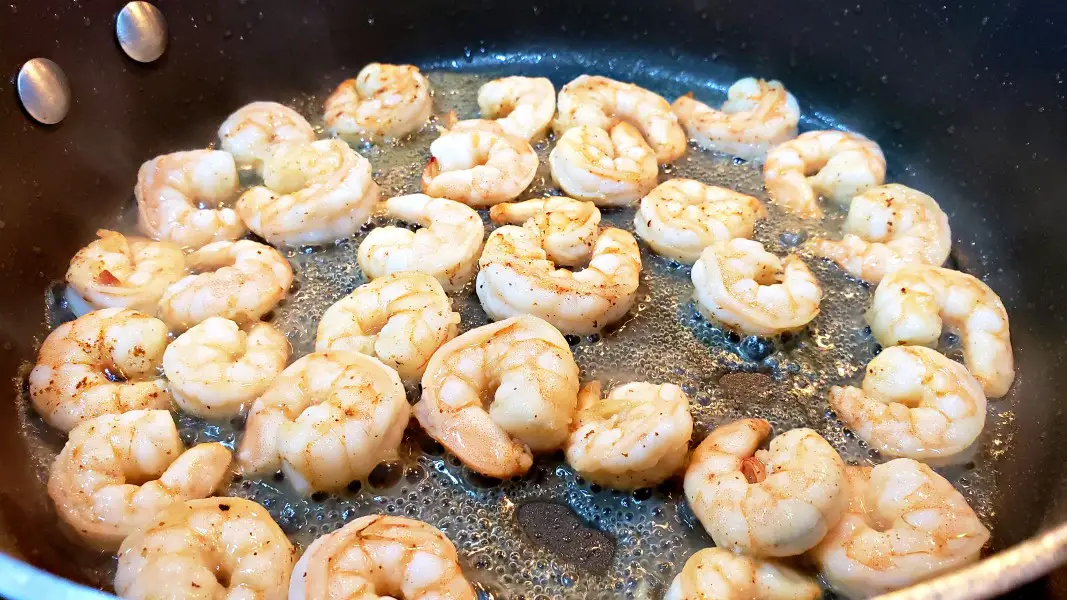 shrimp frying in a pan.
