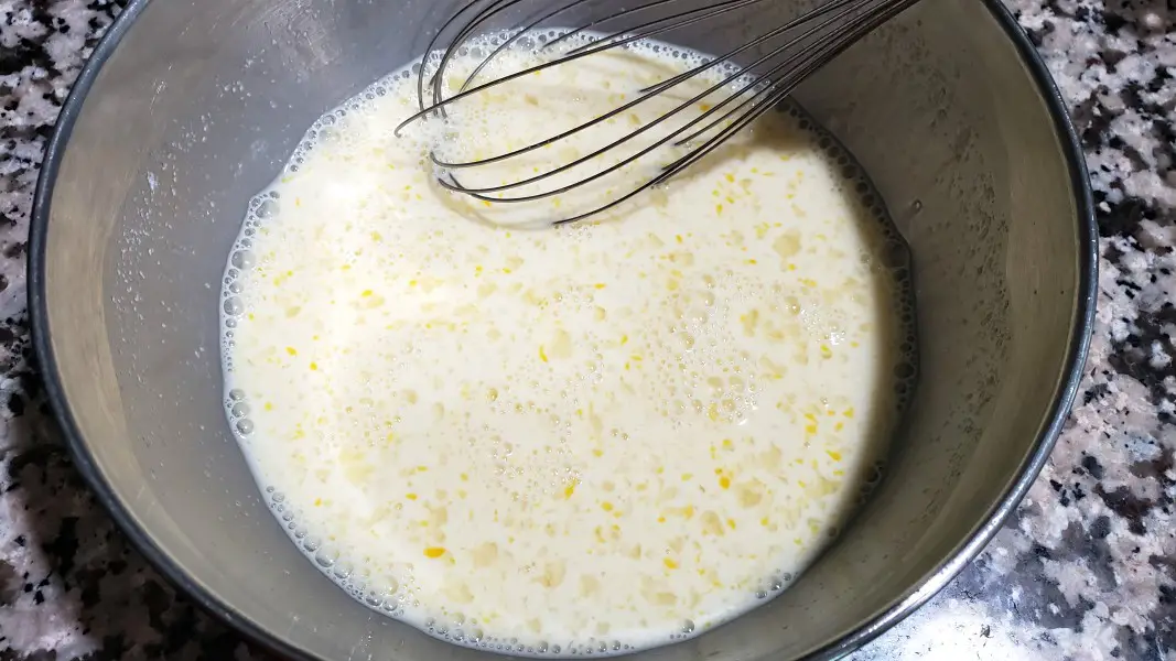 milk, cornstarch, sugar, egg, lemon juice, and vanilla whisked in a bowl.