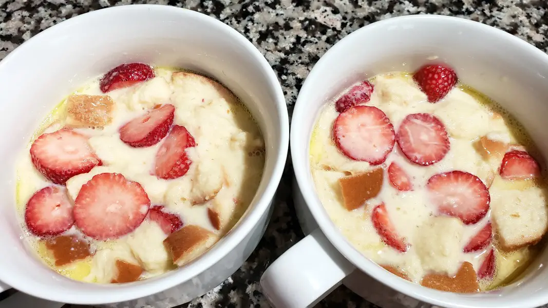 uncooked strawberry bread pudding in two dishes.
