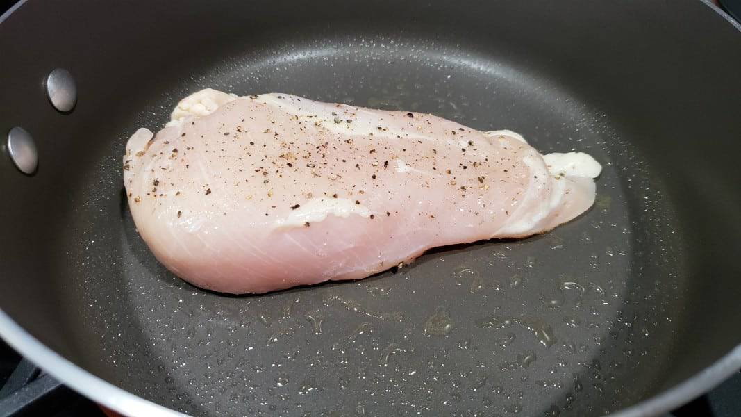 boneless chicken frying in a pan.