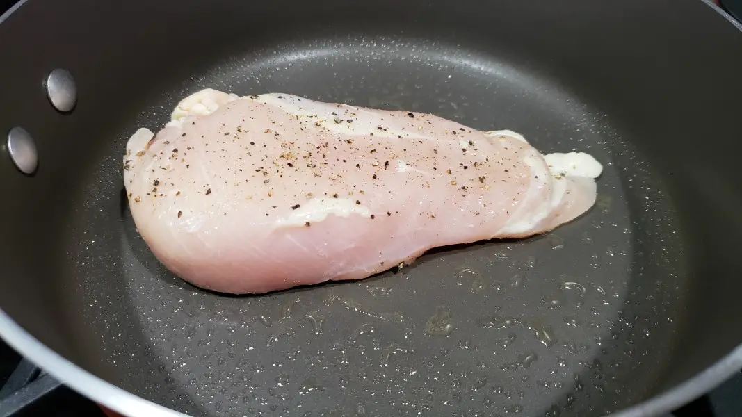 boneless chicken frying in a pan.
