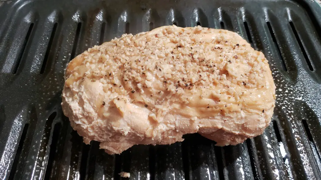 cooked bonless turkey breast on a broiler pan.
