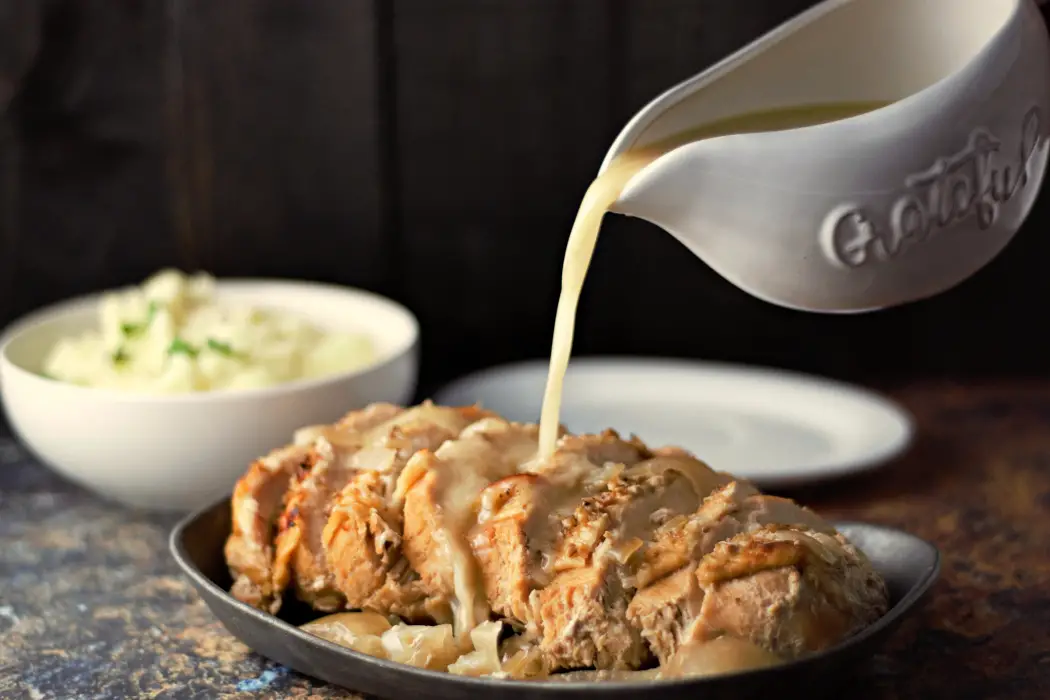 Easy Slow Cooker Turkey Breast with Gravy pouring over it.